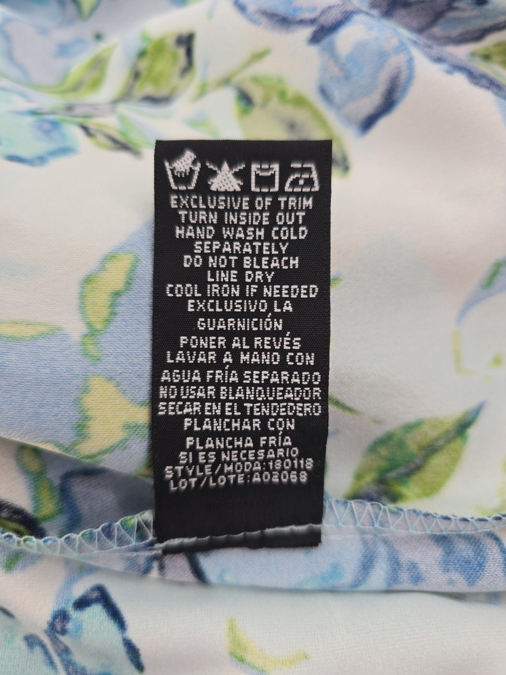 Care instructions tag for Ronni Nicole floral sleeveless dress with wash and dry details