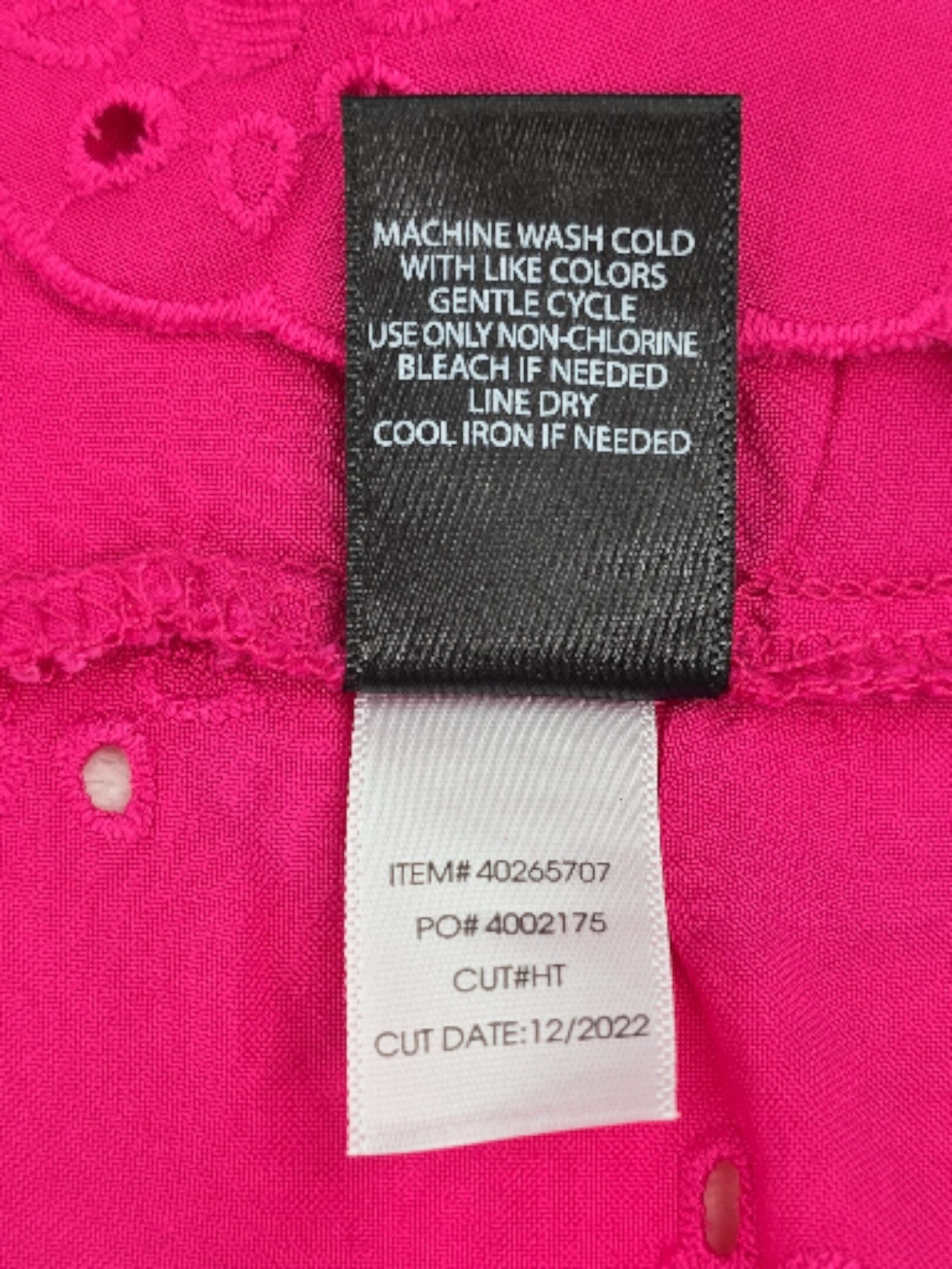 Care label for Torrid pink eyelet cami with machine wash cold instructions