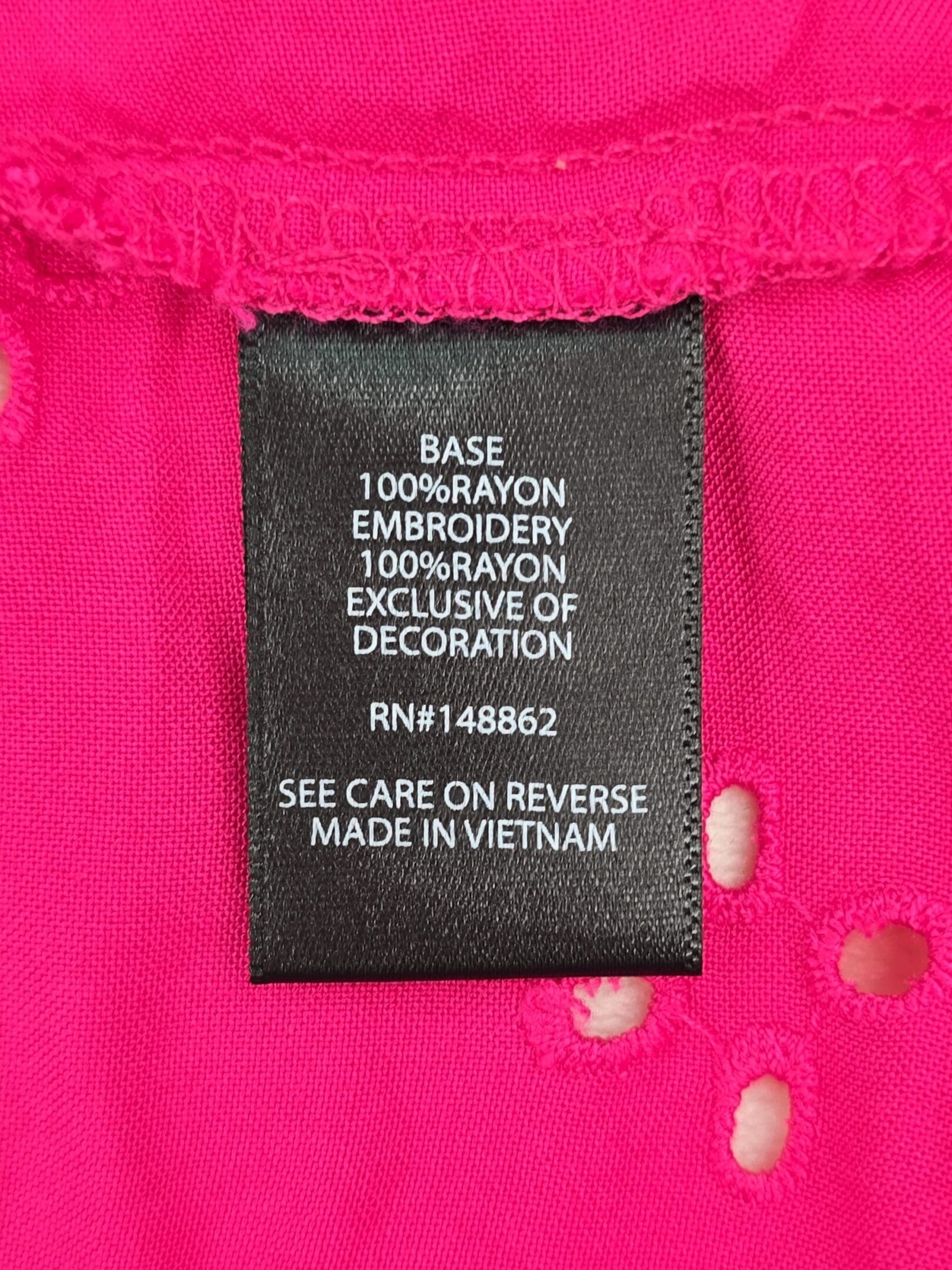 Material content tag for Torrid pink eyelet cami 100% rayon
