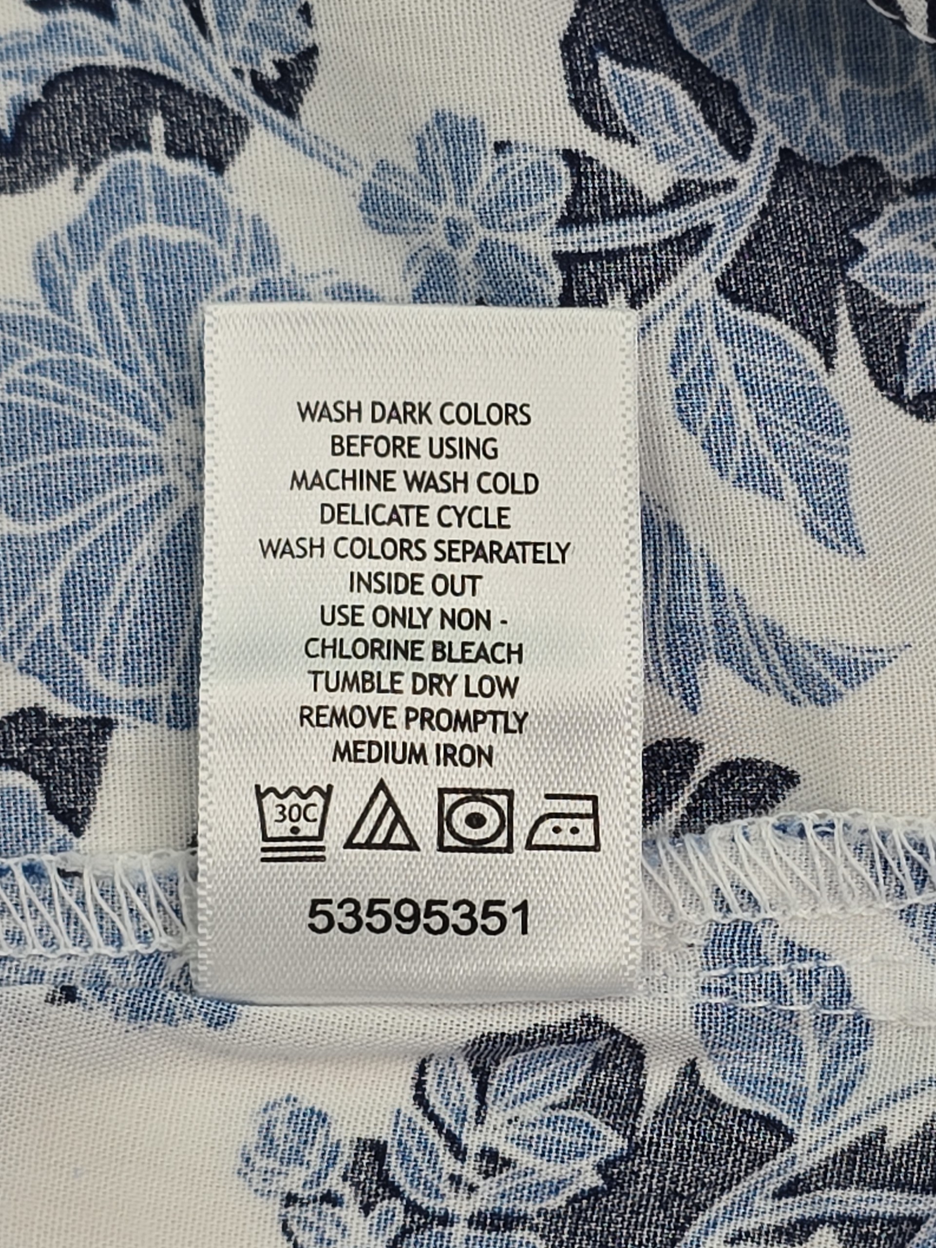 Woman Within sleeveless blouse care instructions tag